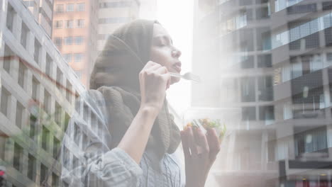 animation of asian woman in hijab enjoying salad, over cityscape