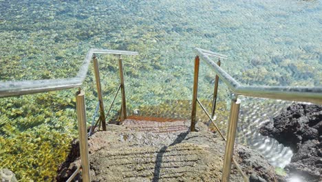 stairway leading to crystal clear atlantic ocean in tenerife, static view