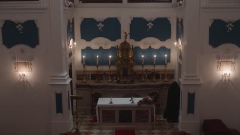 a beautiful scene of a nun in the church next to the altar