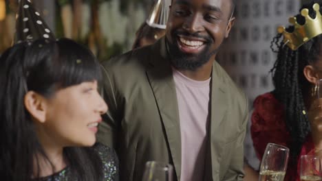 Close-Up-Shot-Approaching-Friends-Dancing-and-Celebrating-New-Years-Eve-In-a-Bar