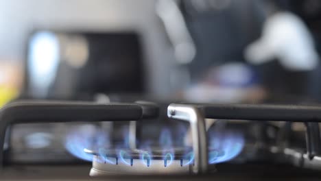 turning gas stove on with flame