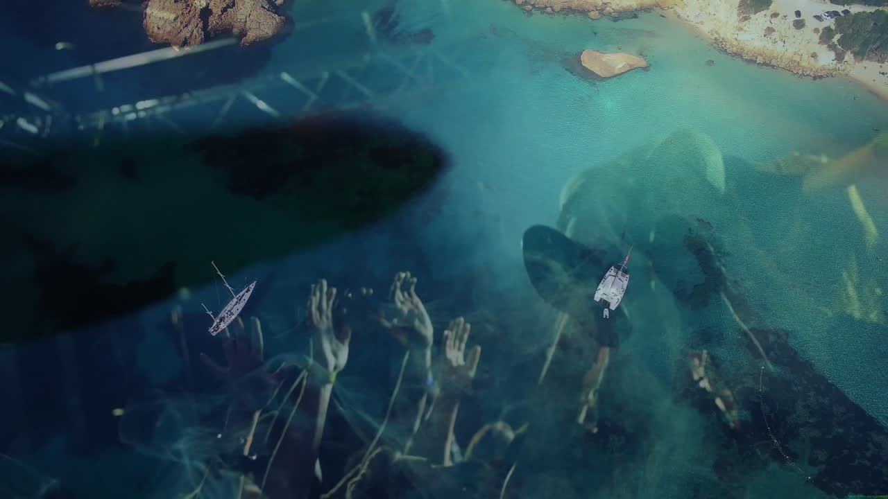 Music event crowd raising hands under spotlight, overlaying turquoise waters with boats drifting