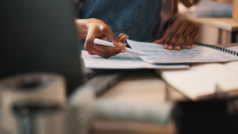 Hands,-writing-and-person-planning-for-taxes