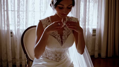 bride getting ready: adjusting wedding shoes