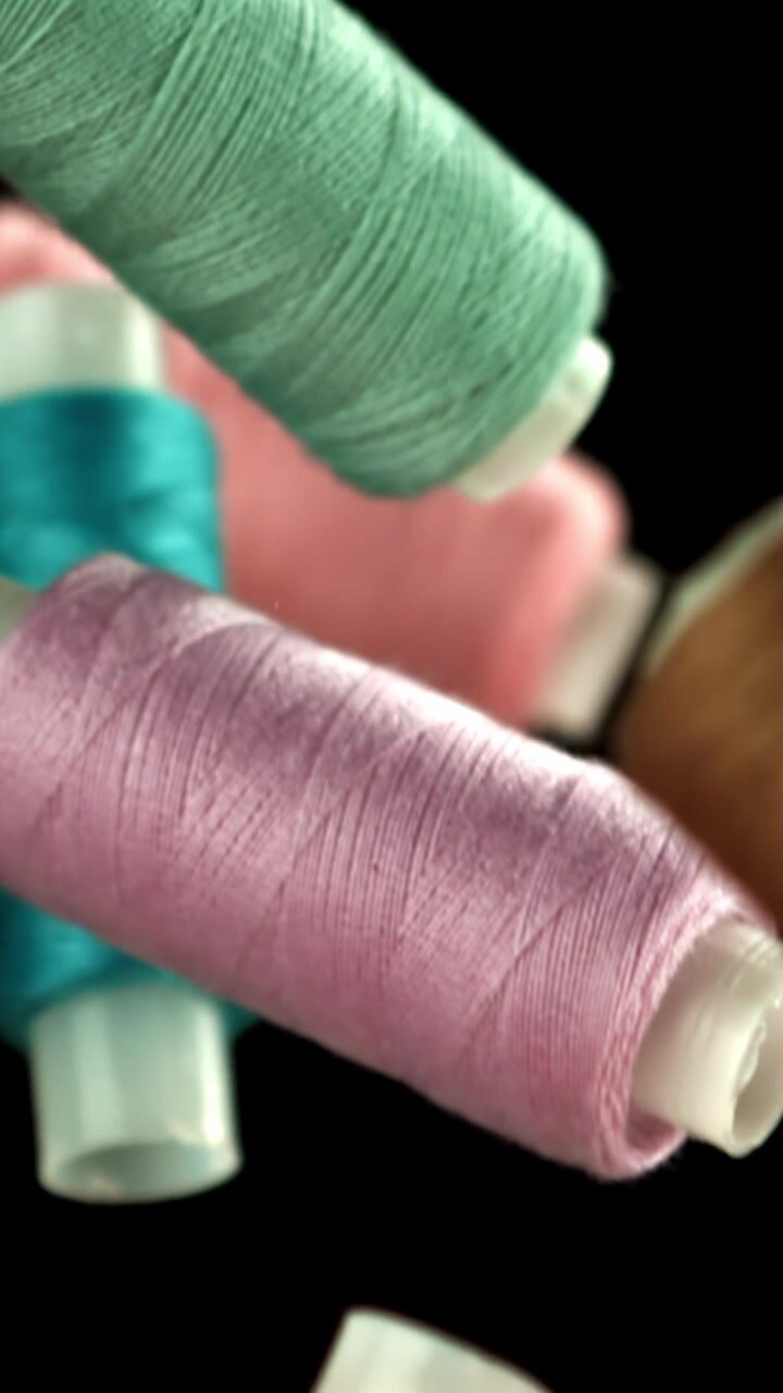 Colorful Sewing Thread Spools on Black Background
