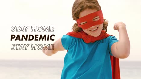 animation of social distancing message flashing over caucasian boy wearing cape and mask