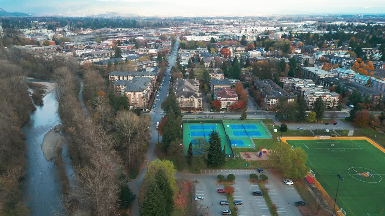 An aerial drone shot of gate's park featuring various sports fields, such as basketball, tennis, volleyball and baseball.