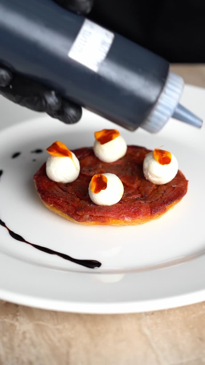 Chef Drizzling Balsamic Glaze on a Gourmet Appetizer