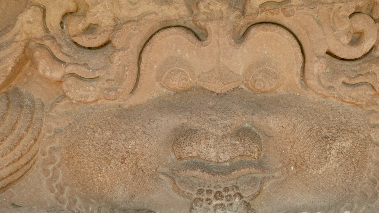 old stone sculpture with artistic carving at indoor