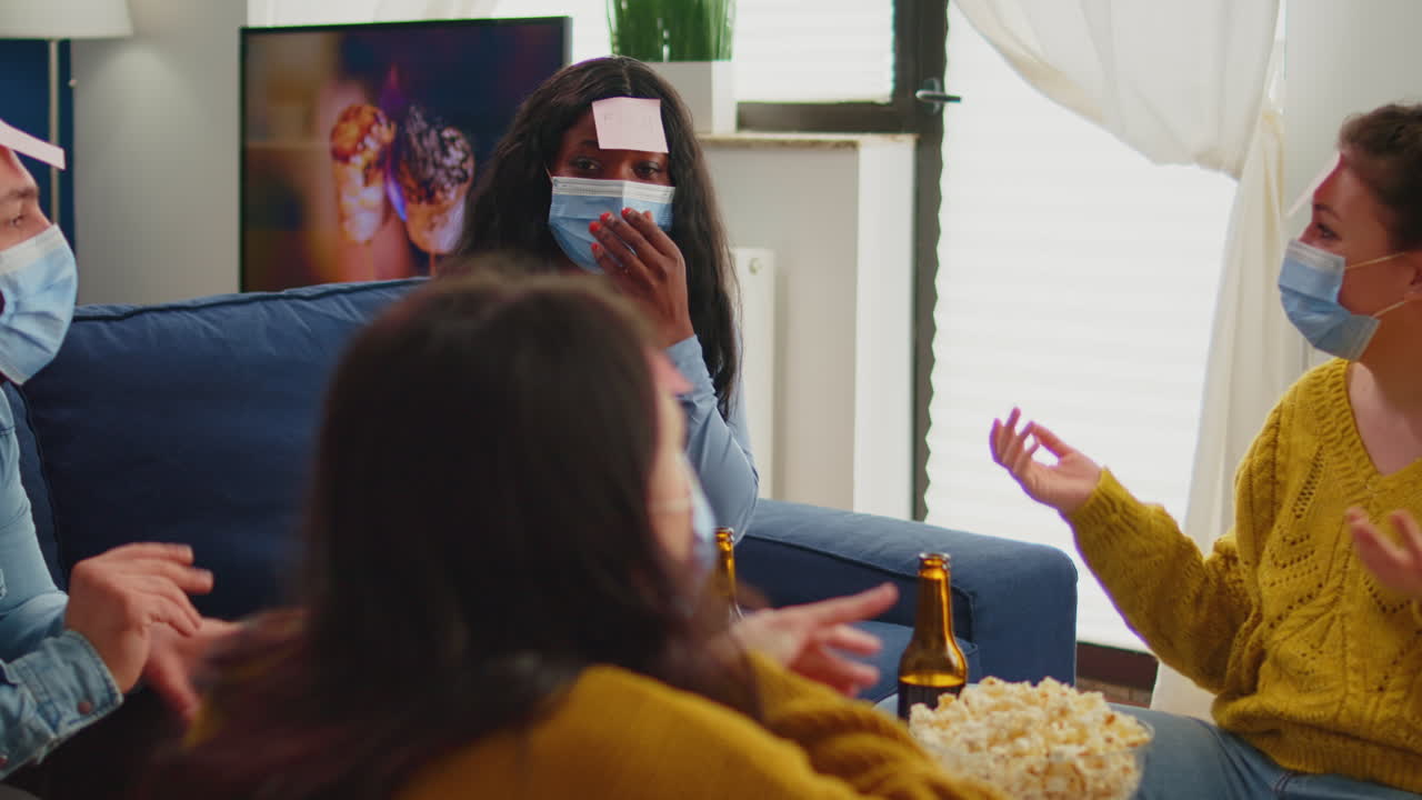 African woman playing name game with sticky notes on forehead