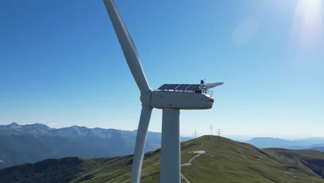 wind turbine with solar panels on a mountain top