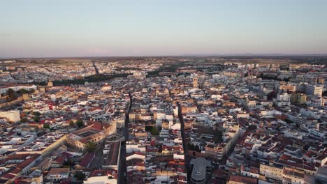 Aerial-orbiting-shot-of-Badajoz-Cityscape-during-sunset,-Spain