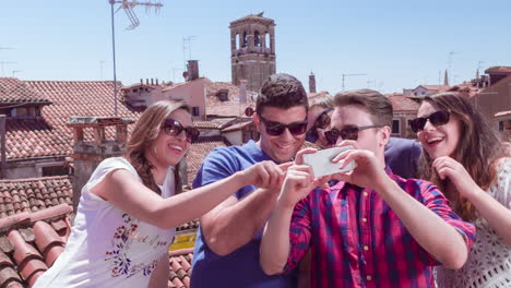 friends taking a selfie on a venetian rooftop