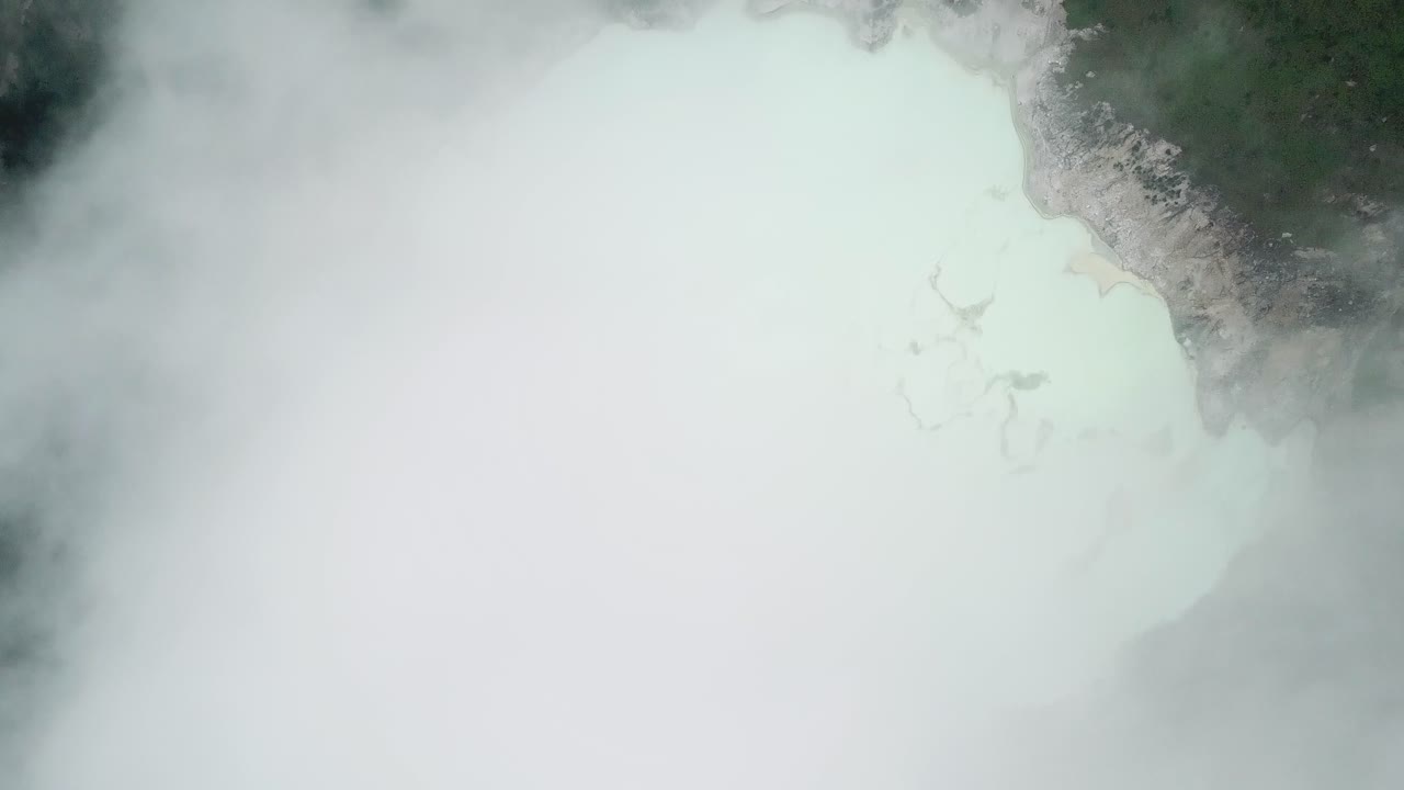 Aerial view of a misty volcano lake