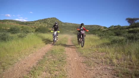 two dirt bike riders on a scenic off-road trail