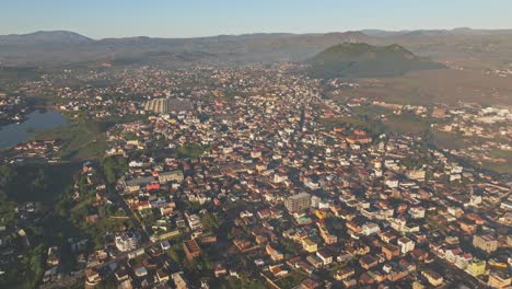 wide aerial drone view of african city with houses on sunny morning