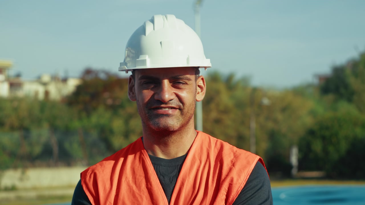 construction worker looking and smiling at the camera