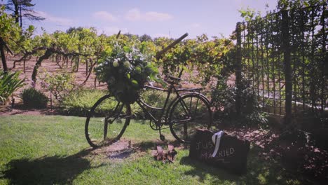 a rustic bicycle decorates a wedding venue, next to a suitcase saying 'just married'