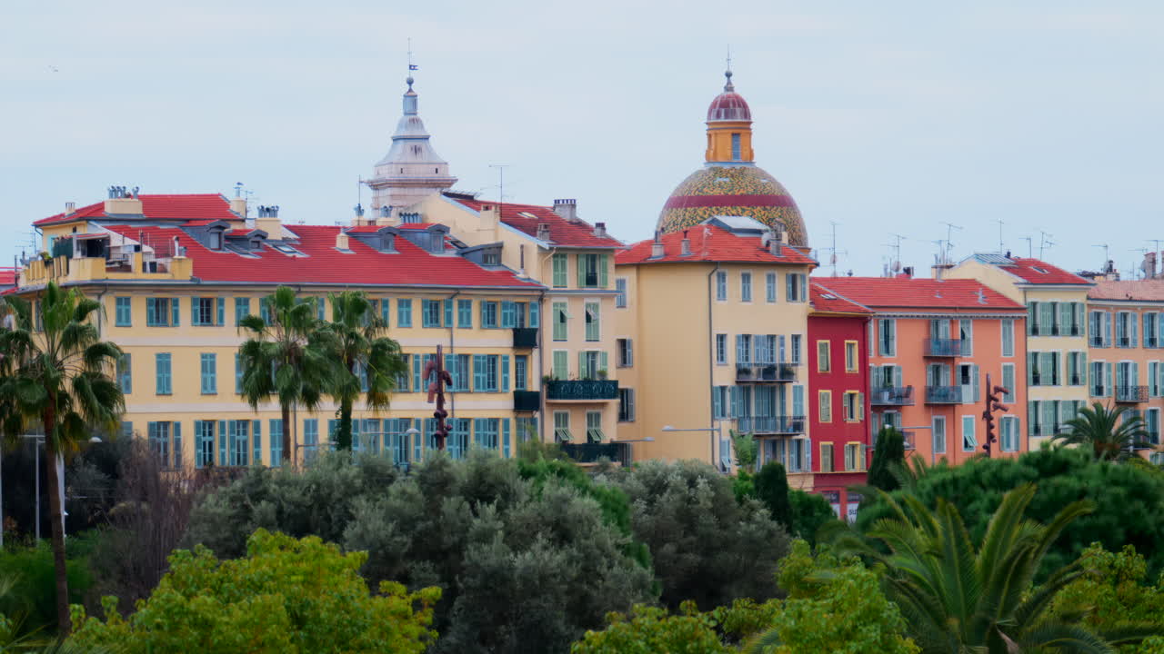 Colourful buildings and trees in the skyline of Nice, France on a cloudy day