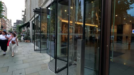 people entering and exiting a revolving door