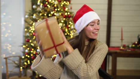 woman excitedly opening a christmas gift