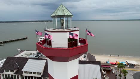 harbor town lighthouse drone tight spin overcast morning