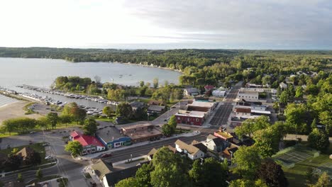 cozy town of suttons bay with boats moored in pier, aerial drone view