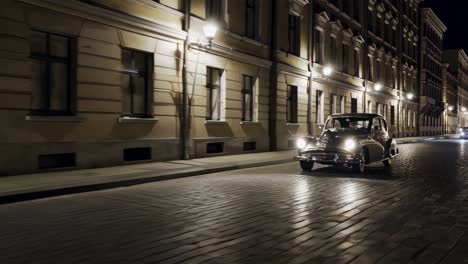 vintage car driving down a city street at night