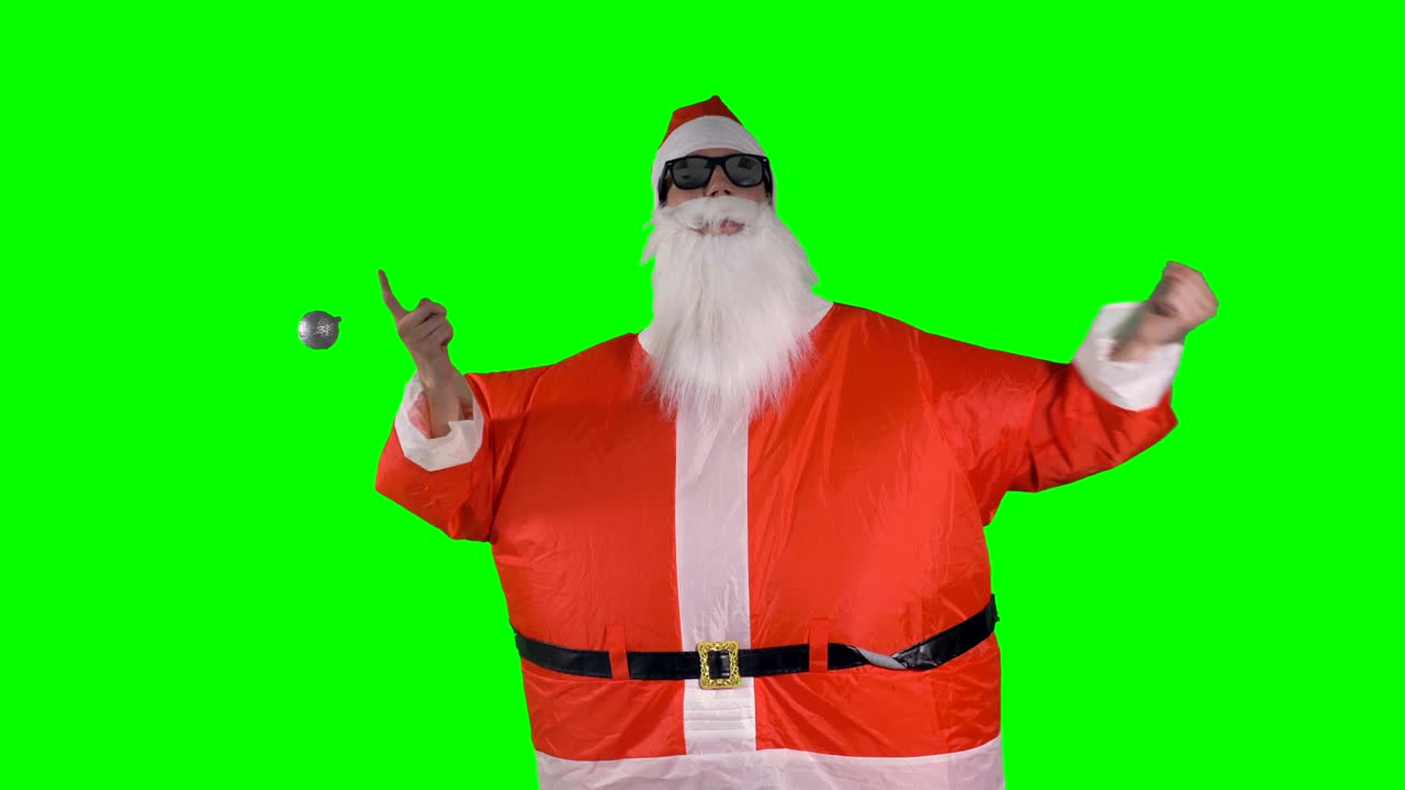 산타클로스는 크리스마스 보블을 흔들고 춤을 춘다.