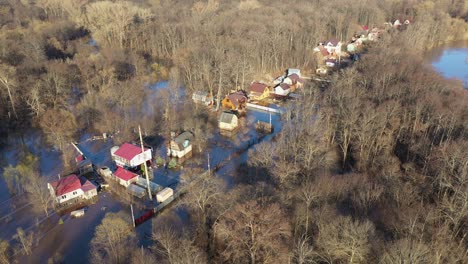 flooded houses by a river that overflowed after rain floods. ecological catastrophe and flooded village and houses. mass natural disasters and destruction.