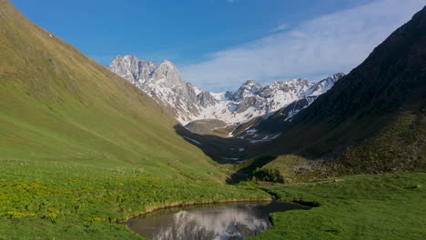 Revealing-drone-shot-of-the-Georgian-Dolomites-reflecting-on-a-small-pond-in-the-Caucasus-mountains-in-Georgia