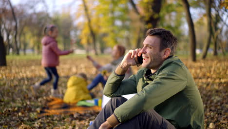 family enjoying a picnic in the autumn park