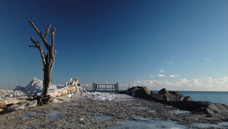 Wide-low-angle-establishing-shot-of-a-long-concrete-jetty-with-a-railing-at-the-end