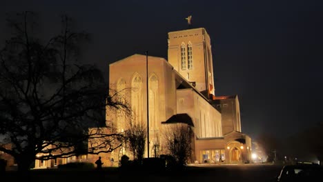 eastern view of guildford cathedral, illuminated by powerful spotlights against the night sky