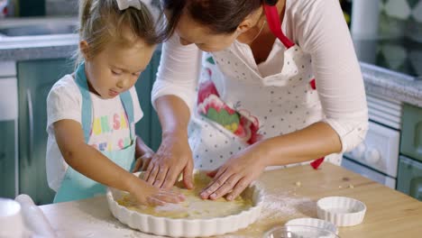 Mother-and-daughter-baking-a-homemade-pie