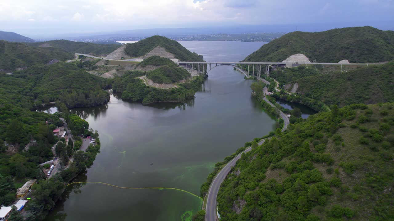 Aerial view of highway bridge over Lake San Roque crossing mountains. Argentina