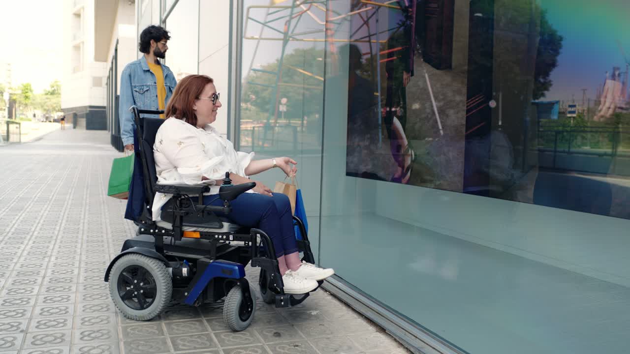 Person in a wheelchair shopping with a companion