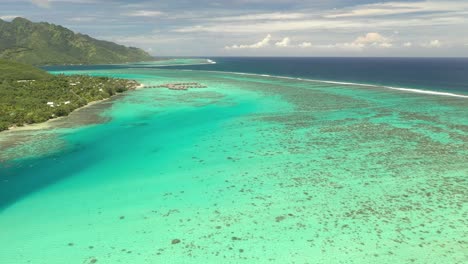 Aerial-establishing-shot-of-the-gorgeous-barrier-reef-surrounding-Mo'orea-island-in-French-Polynesia