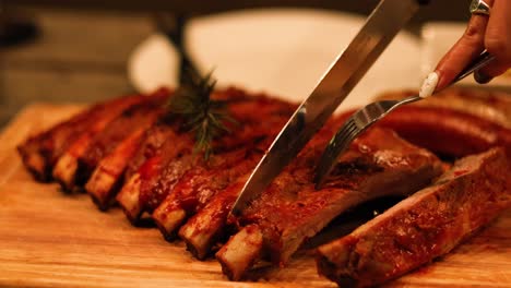 carving succulent ribs on a wooden board