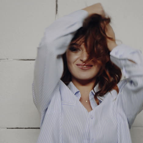 woman with windblown hair in striped shirt