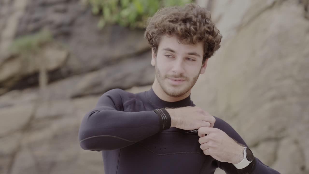 Smiling Young Man in Wetsuit Outdoors
