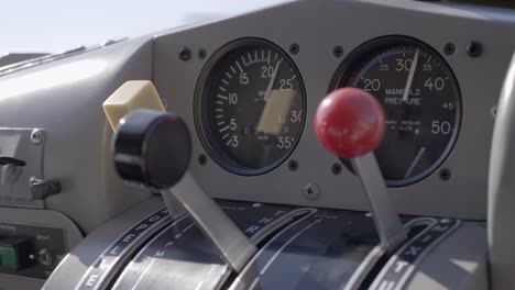 close up cockpit engine control throttle levers of aircraft flying