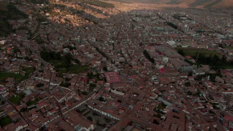 4k aerial view at sunset over the city centre and plaza de armas in cusco, capital of the inca