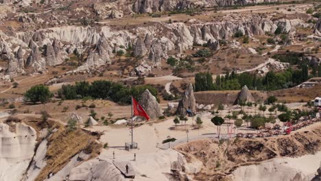 aerial telephoto orbit above turkish flag overlooking cappadocia turkey