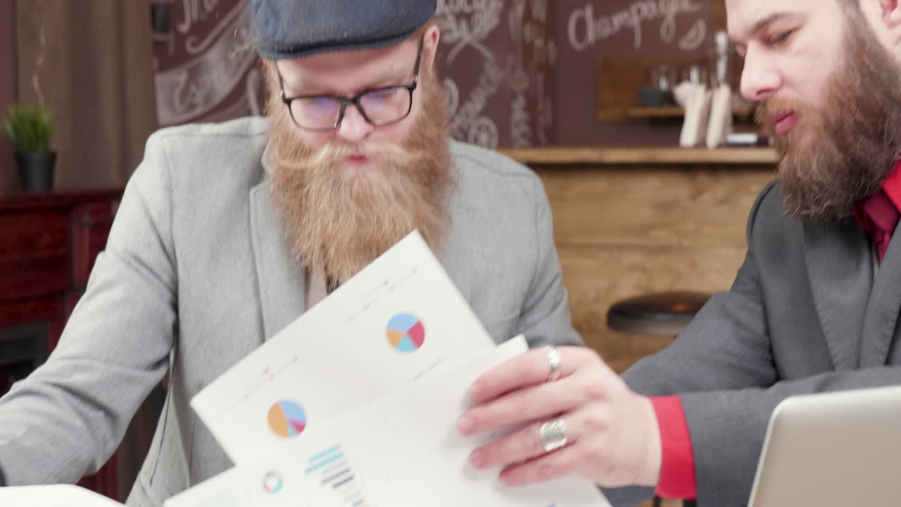 Businessmen Analyzing Charts and Graphs