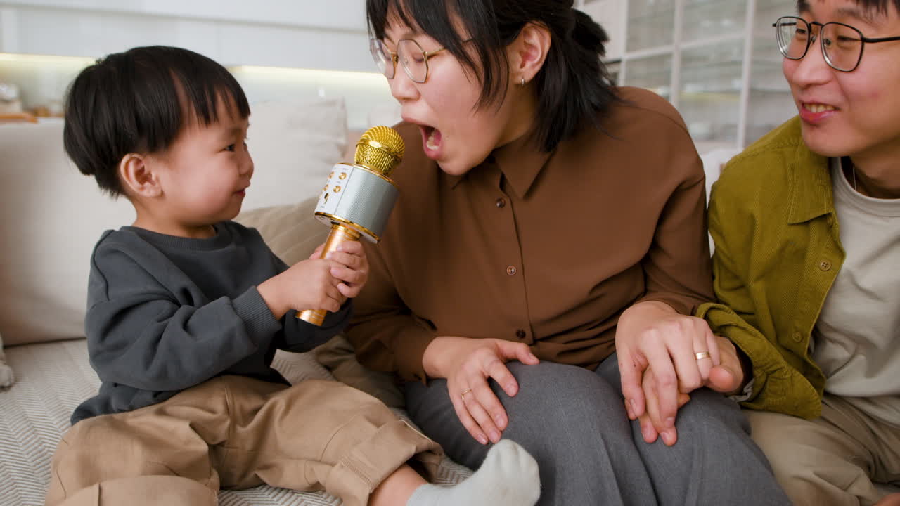 Happy Family Singing with Microphone