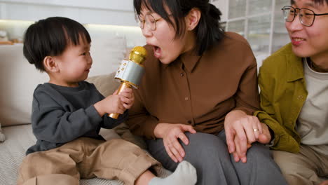 happy family singing with microphone