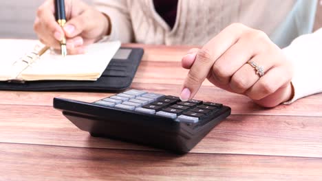 Woman Calculating and Writing