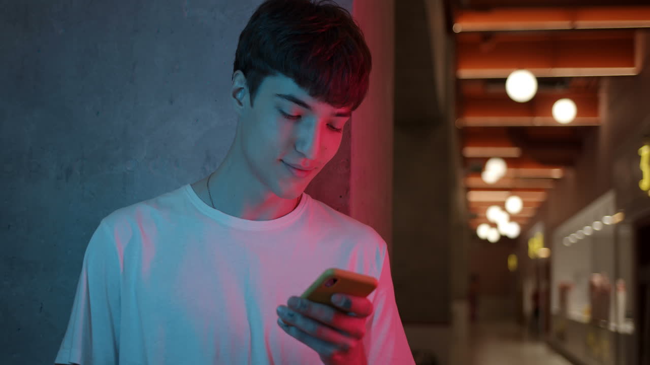 Young man using his phone indoors
