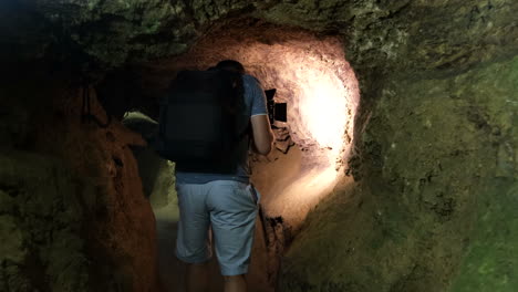 man photographing in a cave